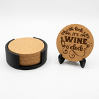 Round cork coasters in a black holder beside an engraved round coaster on a display stand.