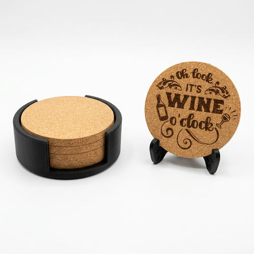 Round cork coasters in a black holder beside an engraved round coaster on a display stand.