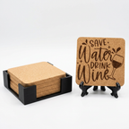 Square cork coasters in a black holder beside an engraved square coaster on a display stand.
